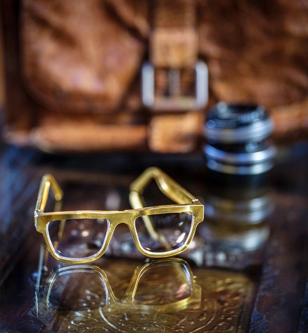 ExoVault eyewear product photograph, styled still life