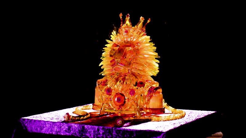 Cinematic sequence still, illuminated crown sculpture on a pedestal