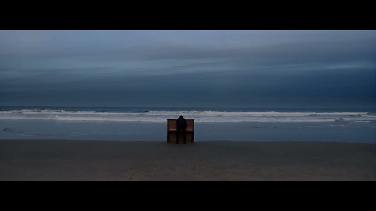 Cinematic brand film still, piano on a beach at dusk